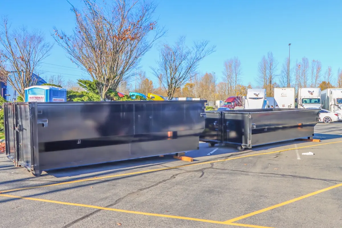 Professional dumpster rental service with roll-off container on residential driveway in Portales